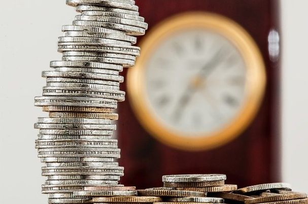 Insider’s Guide to Social Security with stack of coins and clock in background.