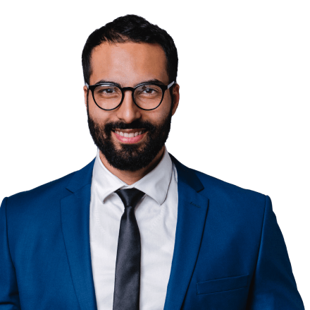 Business owner wearing a suit and reading glasses.