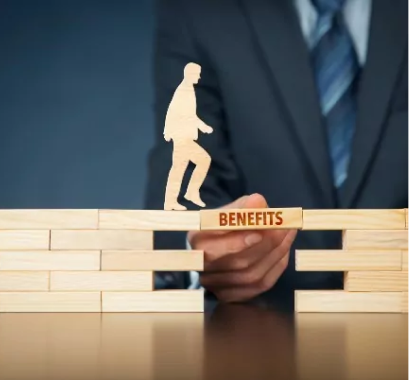 Employer sponsored plans concept of man stepping on wood block labeled benefits that is held up by a financial advisor.